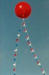 Big Helium Balloons - 7ft. ball with pennants. Pennants add some additional color to big balloons. Big helium balloons build traffic!