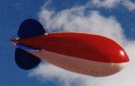 Advertising Blimp - RWB in air - 11ft. blimps-$664.00, 14ft. blimps- $805.00-artwork additional. We manufacture our helium balloons and advertising blimps in the USA. no pvc! Click on photo to take you to advertising blimps.